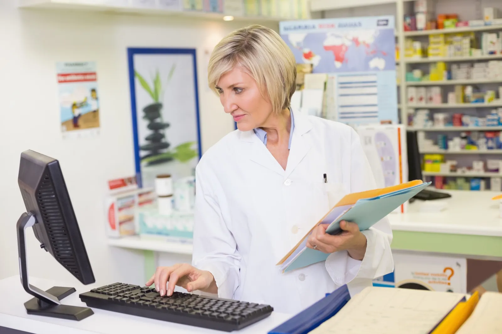 Pharmacist working at a computer in a health system pharmacy